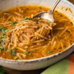 spoon lifting noodles in Sopa de Fideo