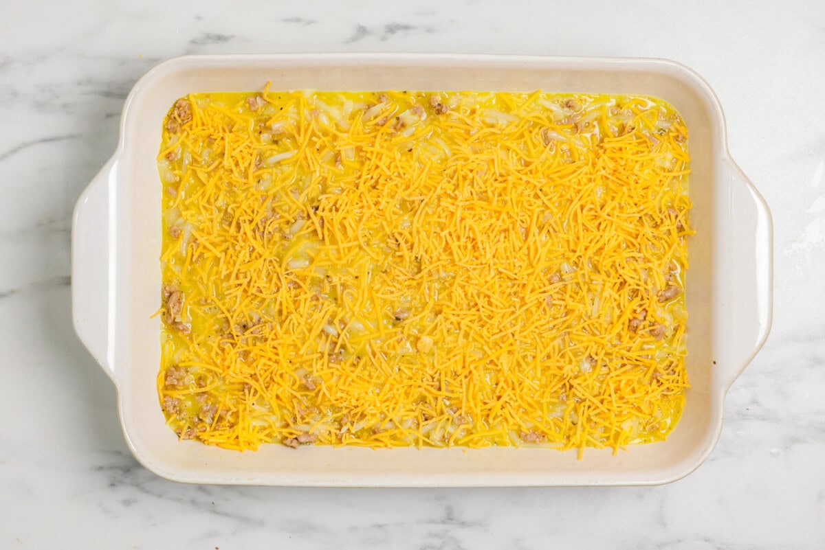 Shredded cheddar cheese on top of turkey hash brown casserole