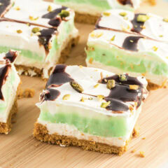 Close up photo of slices of Pistachio Lush on a wooden board