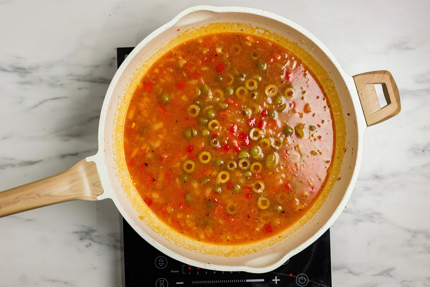 olives added to broth and veggies in skillet
