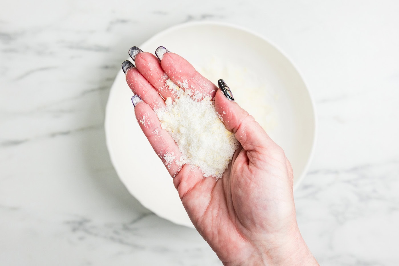 hand holding sugar rubbed with lemon zest