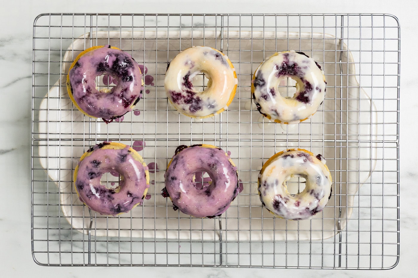 glazed Blueberry Donuts on wire rack