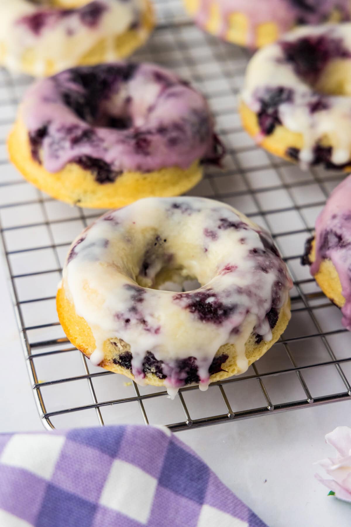 close up of Blueberry Donuts on wire rack