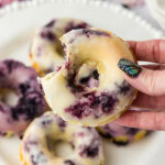 hand holding a glazed Blueberry Donut