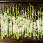 pan of asparagus with cheese melted on top