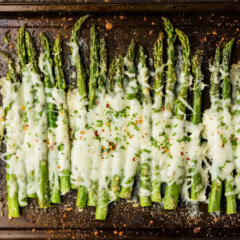 pan of asparagus with cheese melted on top