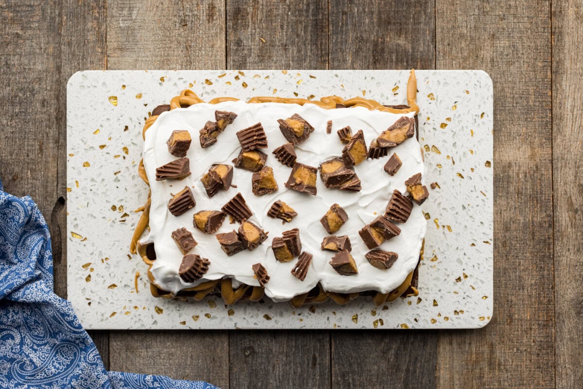 top of ice cream sandwich cake dotted with chopped peanut butter cups