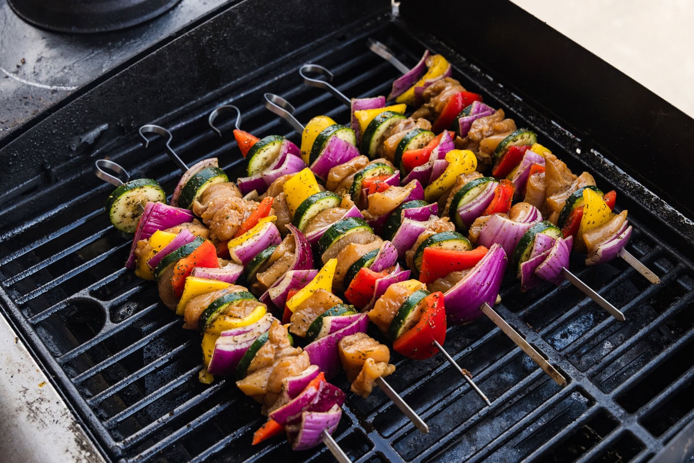 skewered marinated chicken and veggies on grill