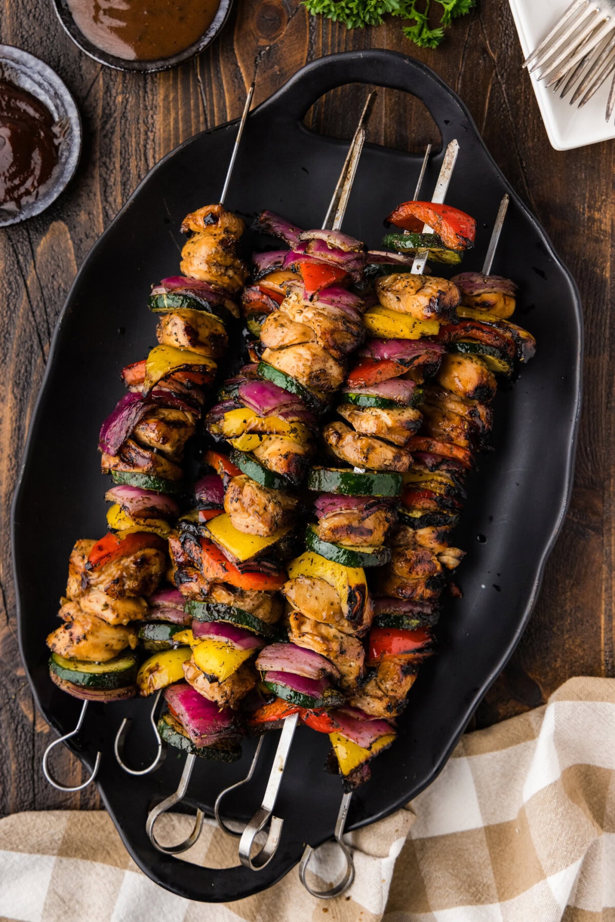 Marinated Grilled Chicken Kabobs on a black platter