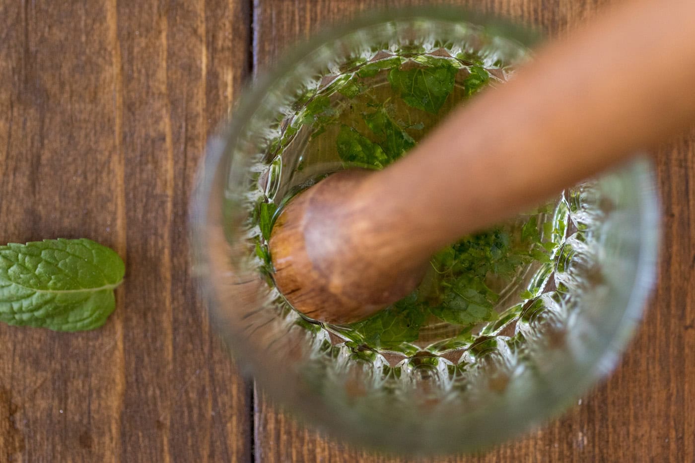 muddling mint in glass