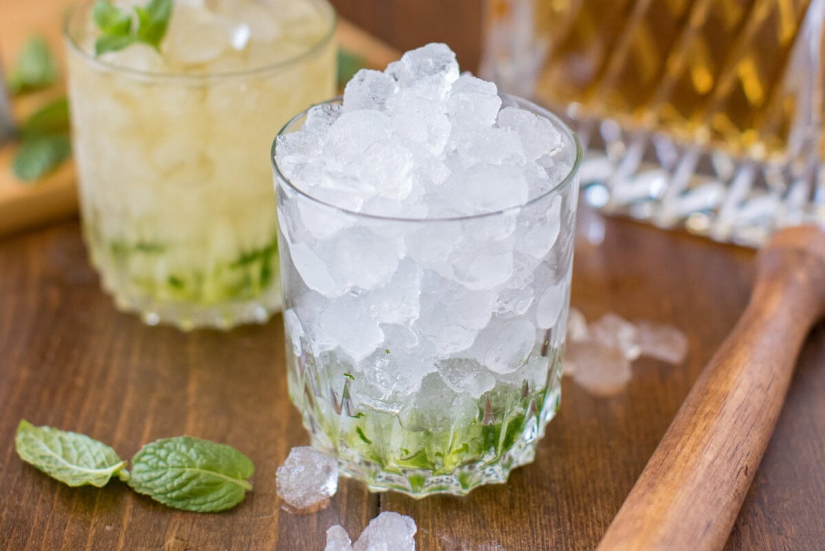 glass with muddled mint and ice