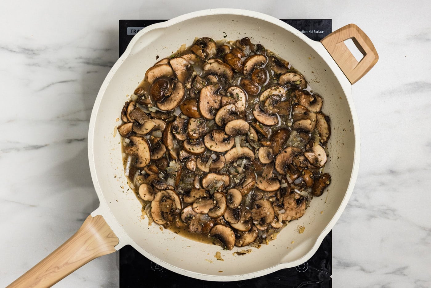 simmering mushrooms in skillet