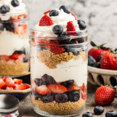 Close up No Bake Berry Cheesecake Trifle in Mason Jars