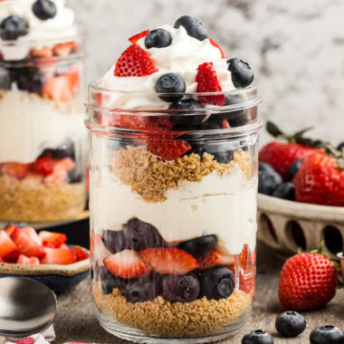 Close up No Bake Berry Cheesecake Trifle in Mason Jars