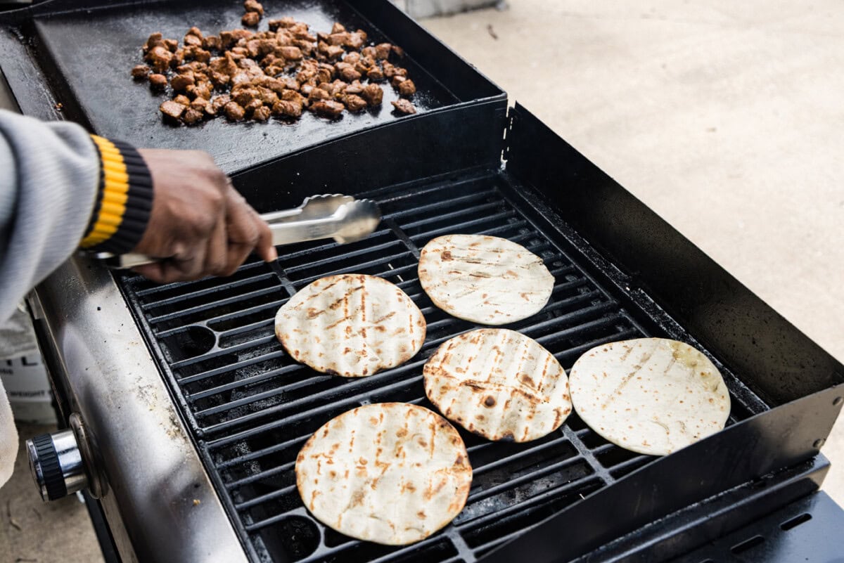 flipping taco shells on grill