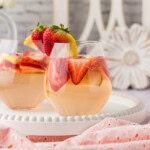strawberry sangria in glass with pitcher