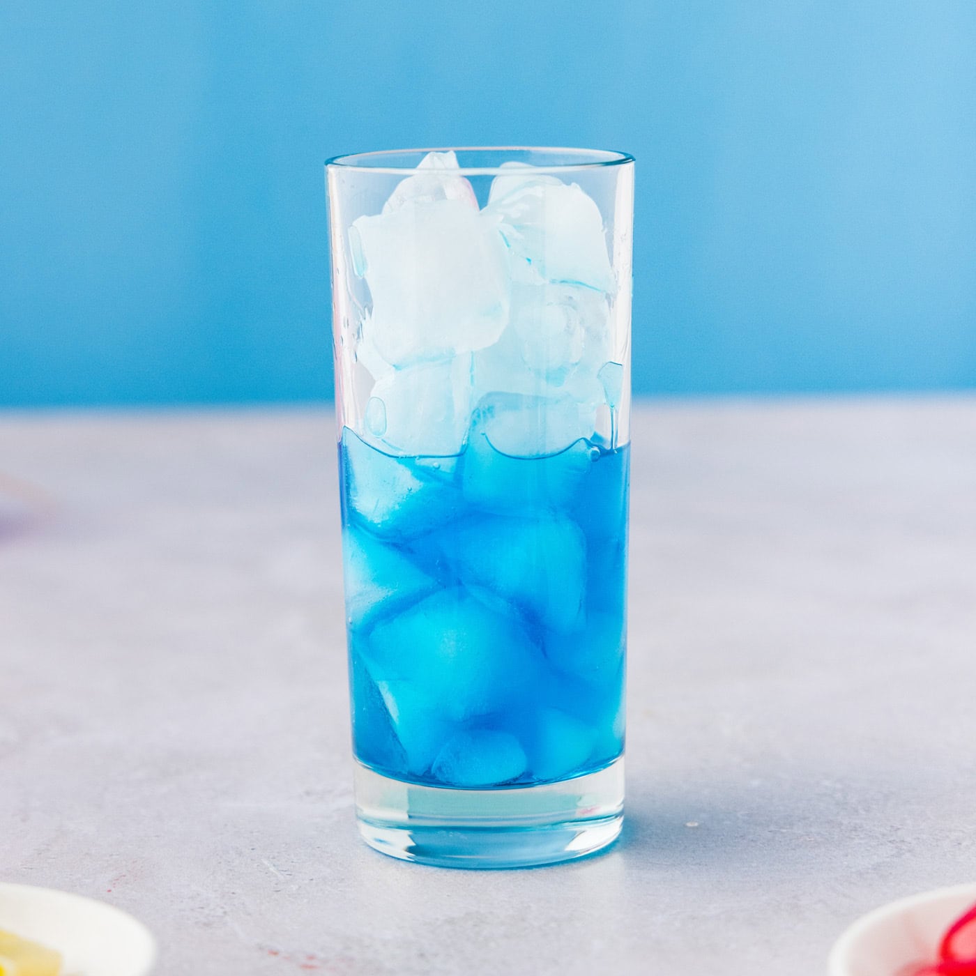 glass of ice with blue curacao
