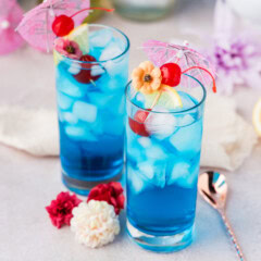 2 Blue Mermaid Cocktails with cocktail umbrellas