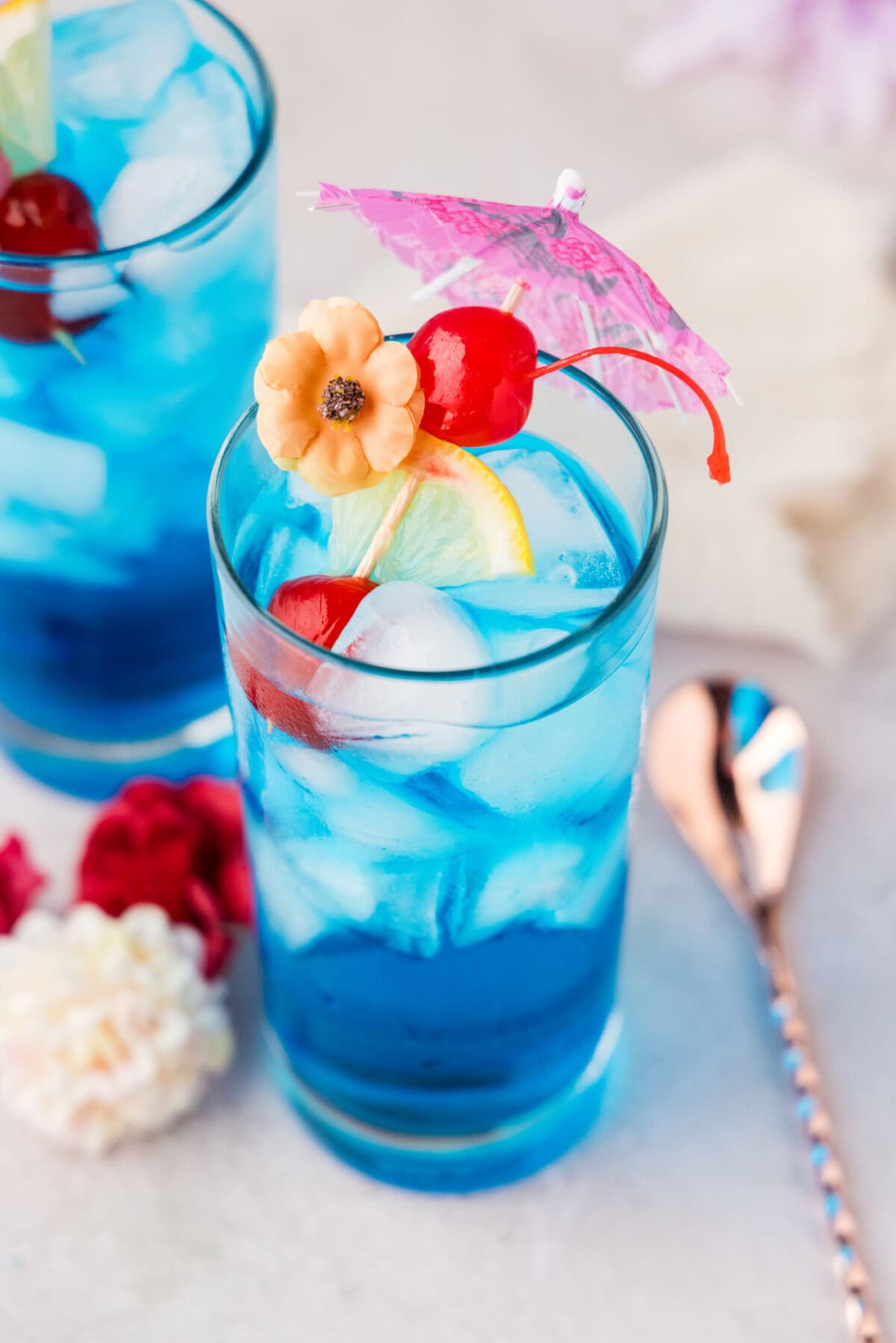 Blue Mermaid Cocktail with a cherry garnish