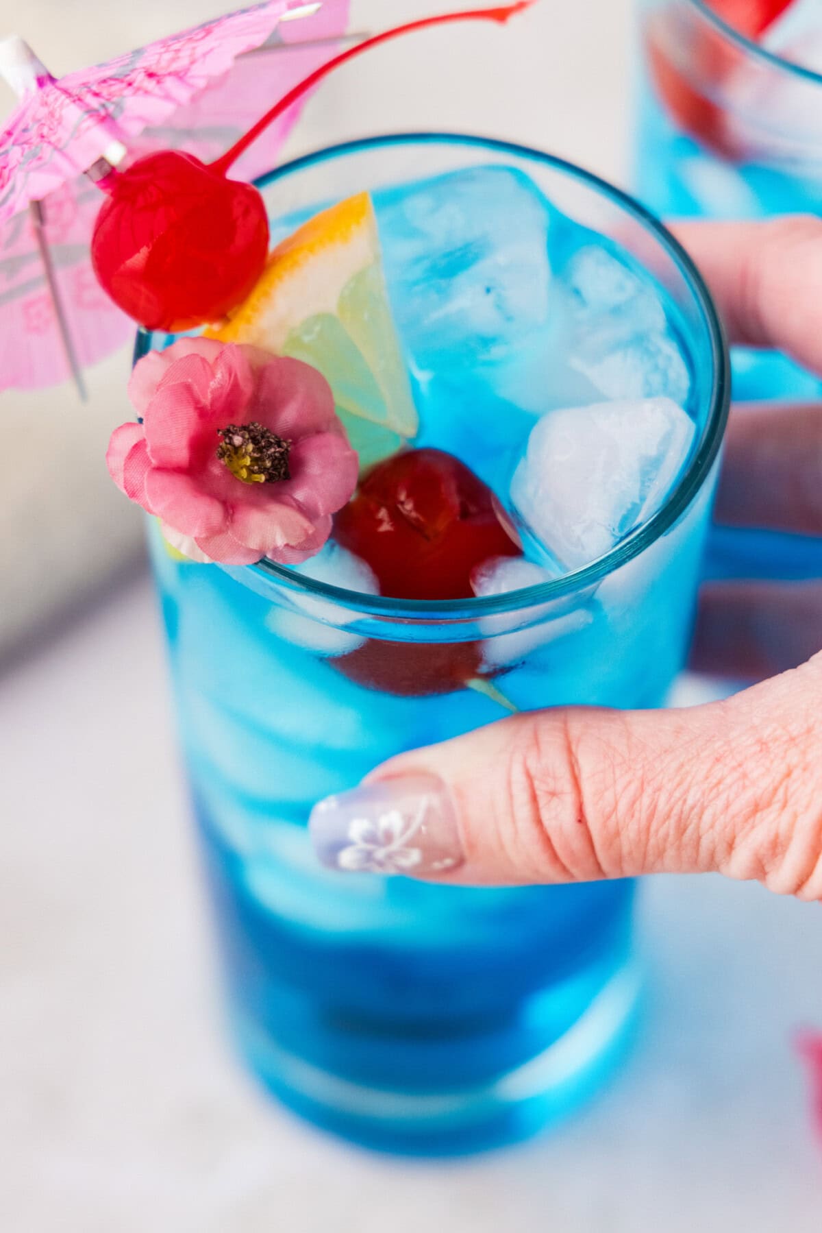 hand lifting a Blue Mermaid Cocktail