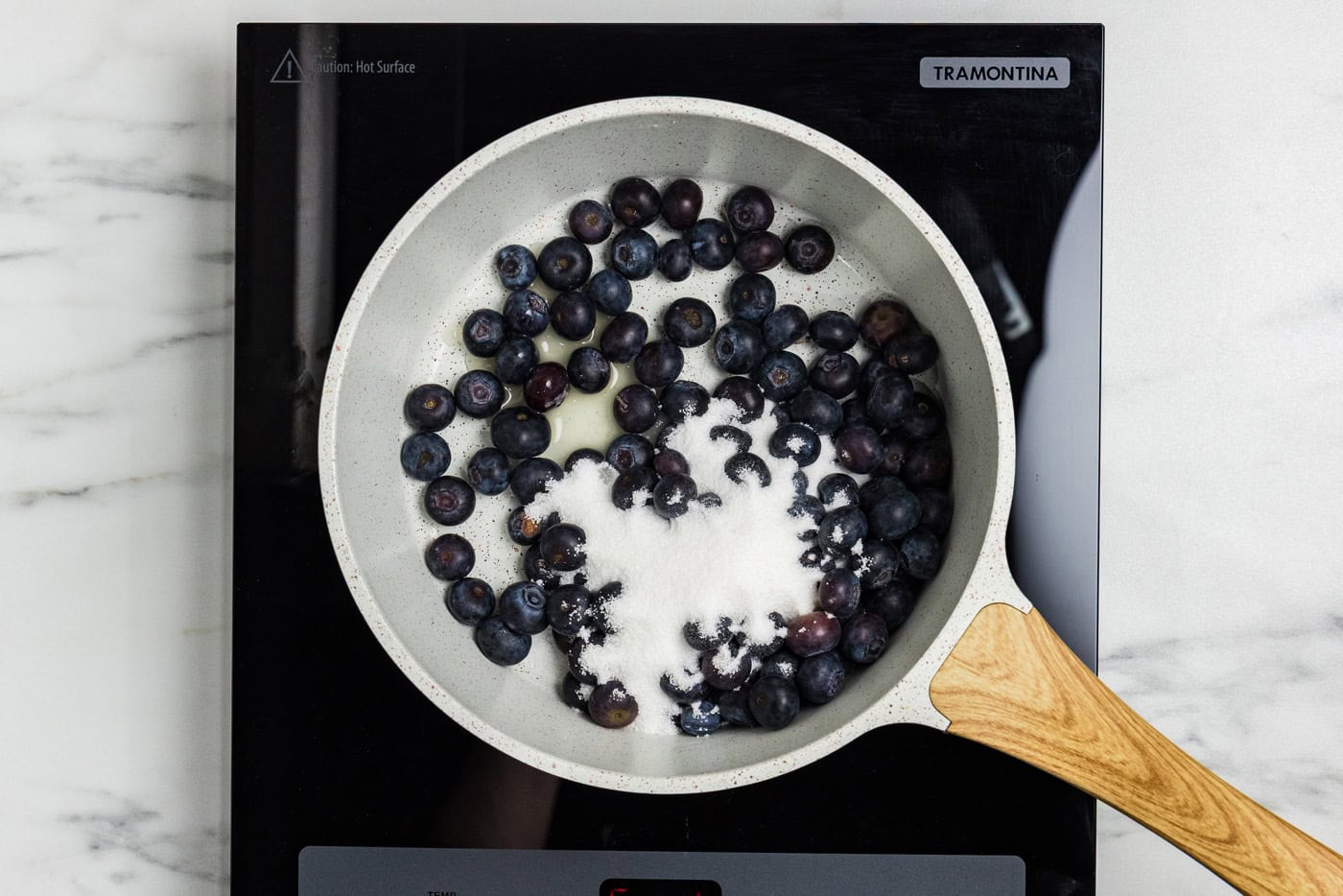 blueberries and sugar in saucepan