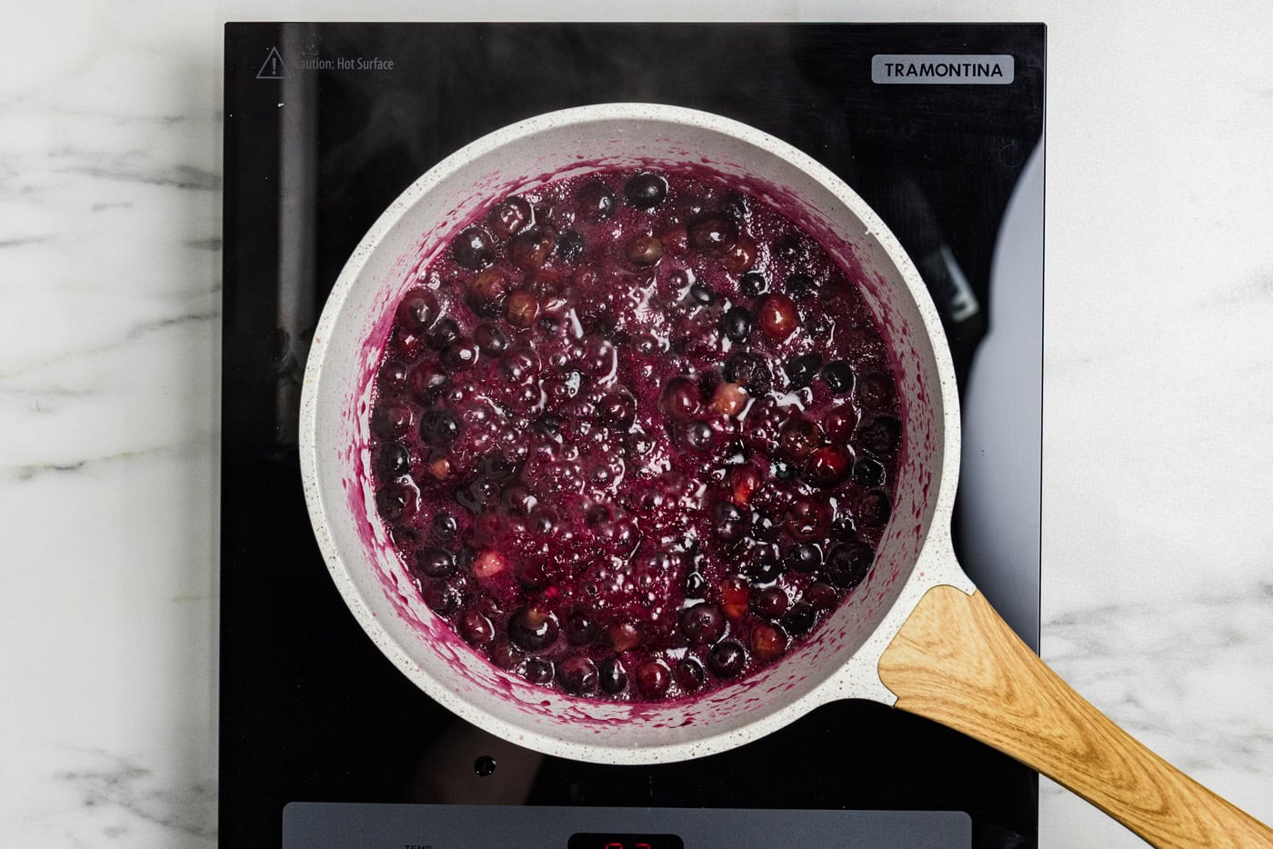 blueberry compote cooking in saucepan