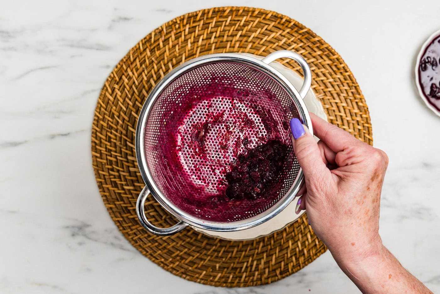 blueberry jam solids in colander