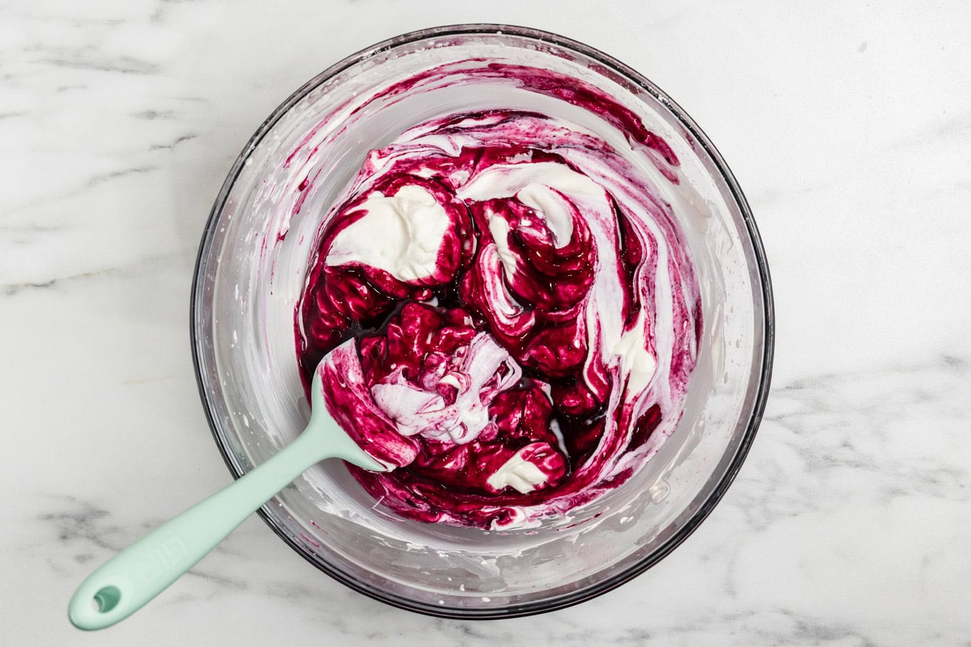 folding blueberry compote into whipped cream mixture