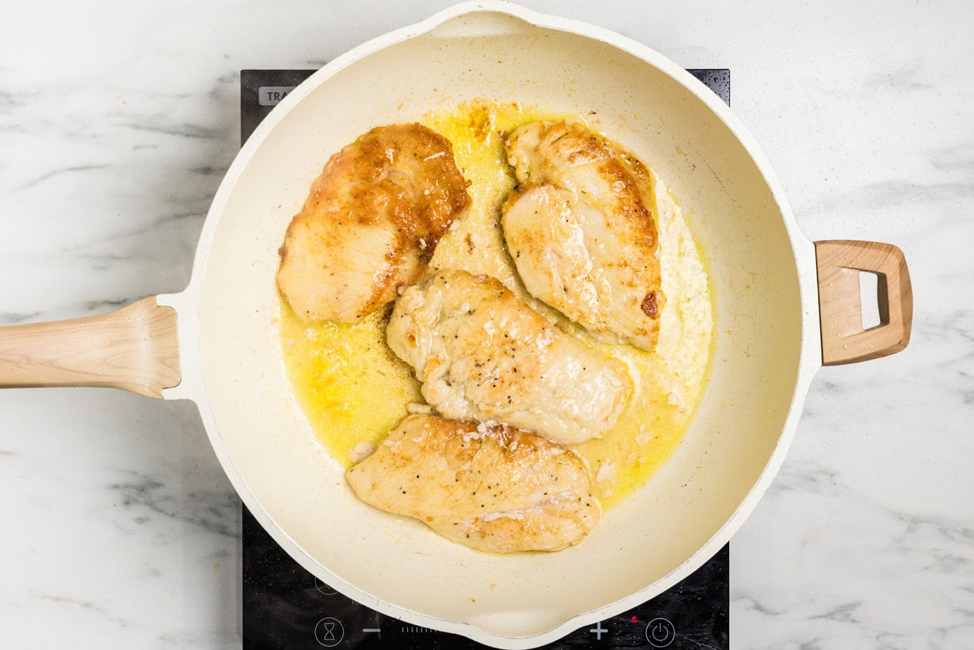 browned chicken cutlets in skillet