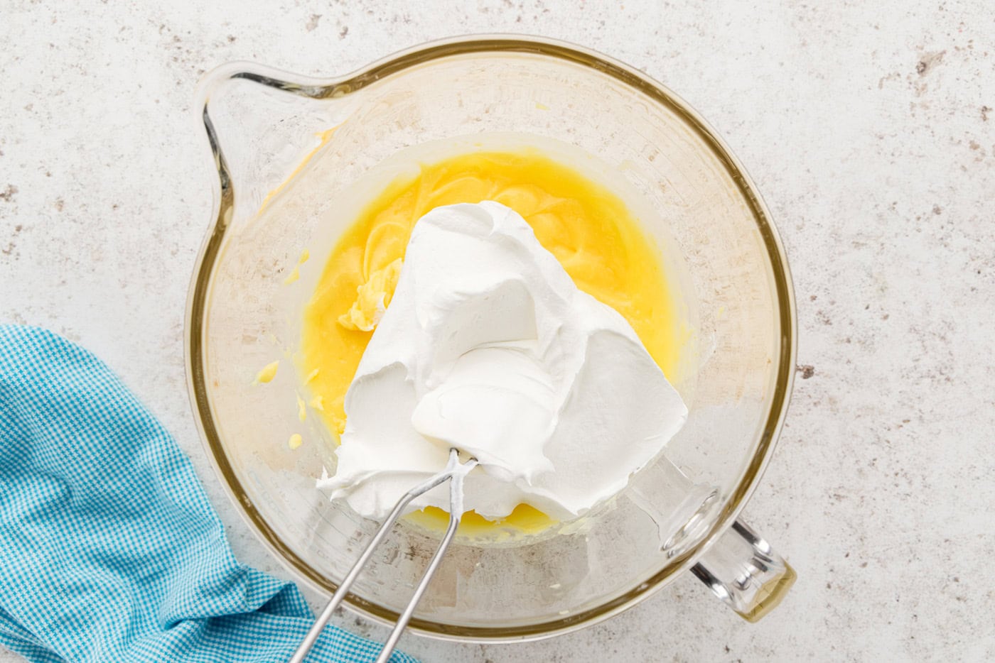 pudding and whipped cream in mixing bowl
