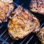 close up of chicken thighs on the grill