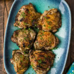 platter of grilled chicken thighs