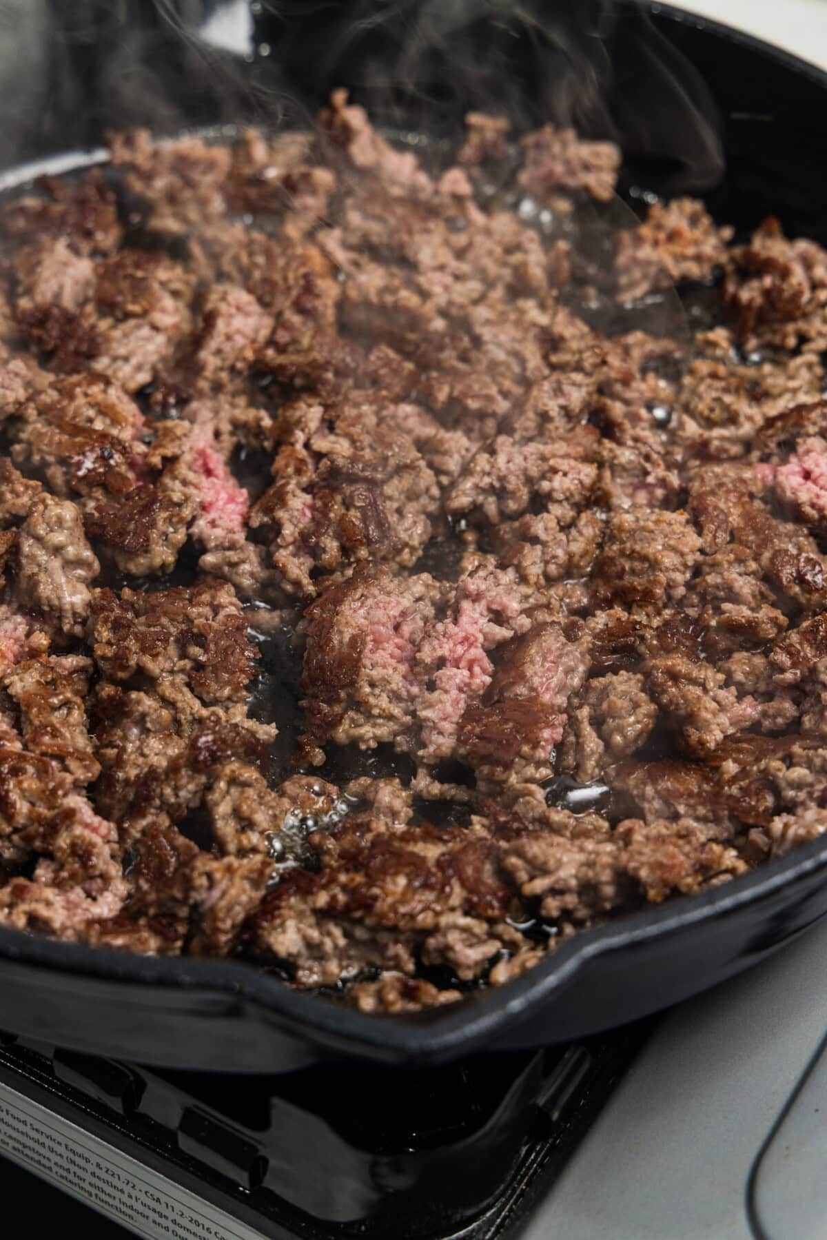 Ground beef searing in skillet