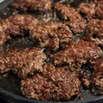 hunks of ground beef nicely browned and caramelized in skillet