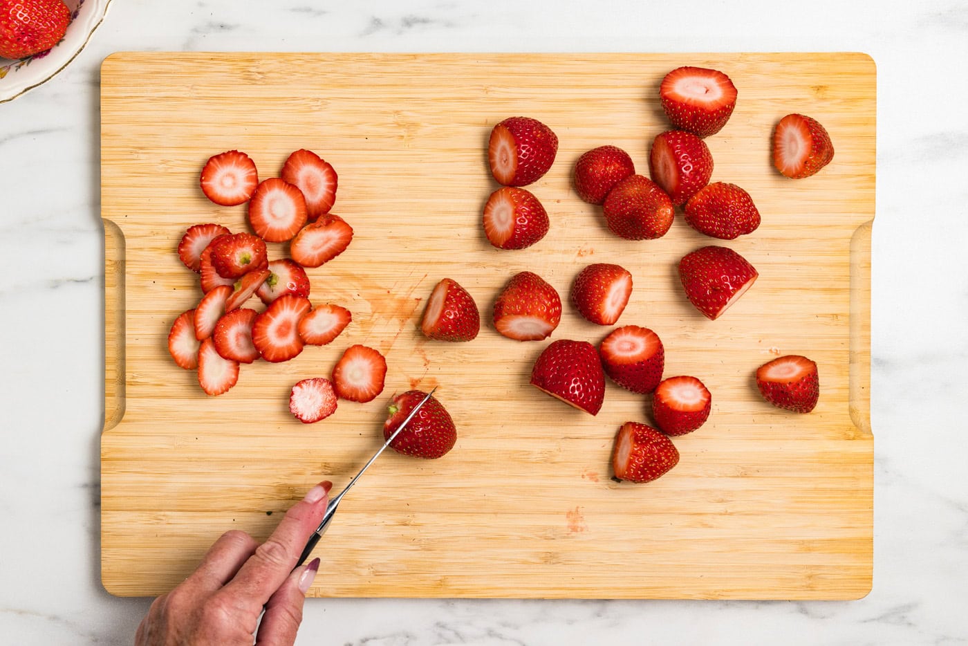 cutting the stem end off strawberries
