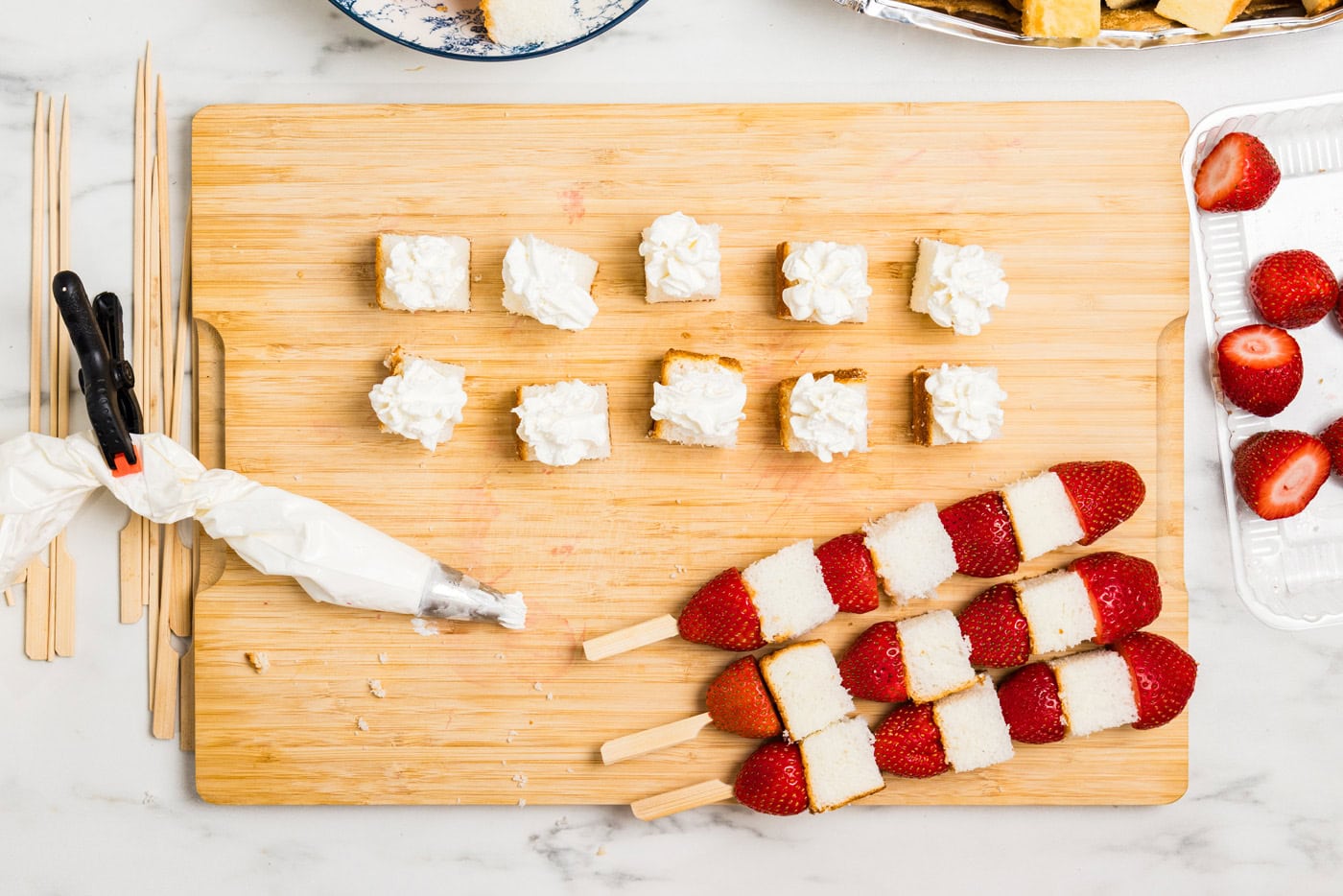 kabobs, angel food cake cubes, and whipped cream piping bag