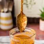 side view of spoon hovering over a jar of Baja Marinade