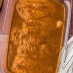 raw chicken in glass dish covered with Baja Citrus Marinade