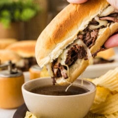dipping a french dip sandwich in au jus