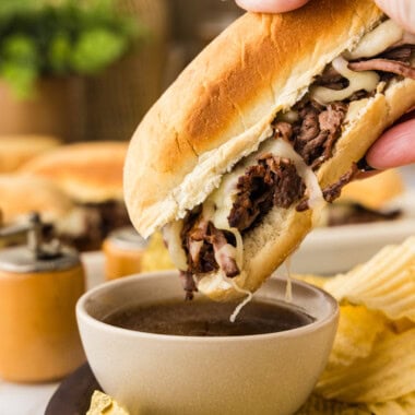 dipping a french dip sandwich in au jus