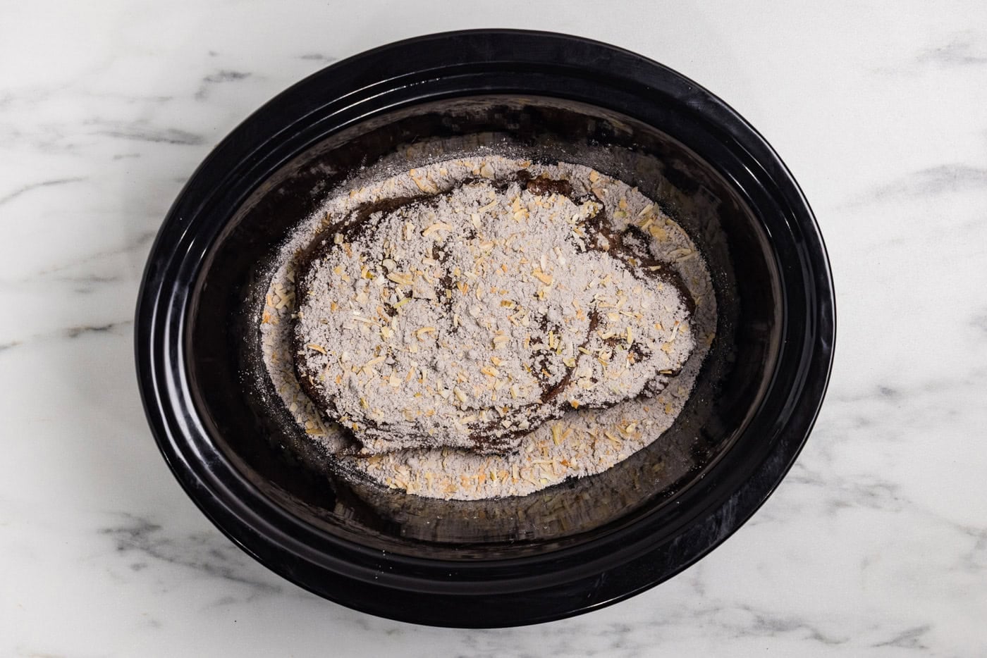 seasonings on top of chuck roast in crockpot