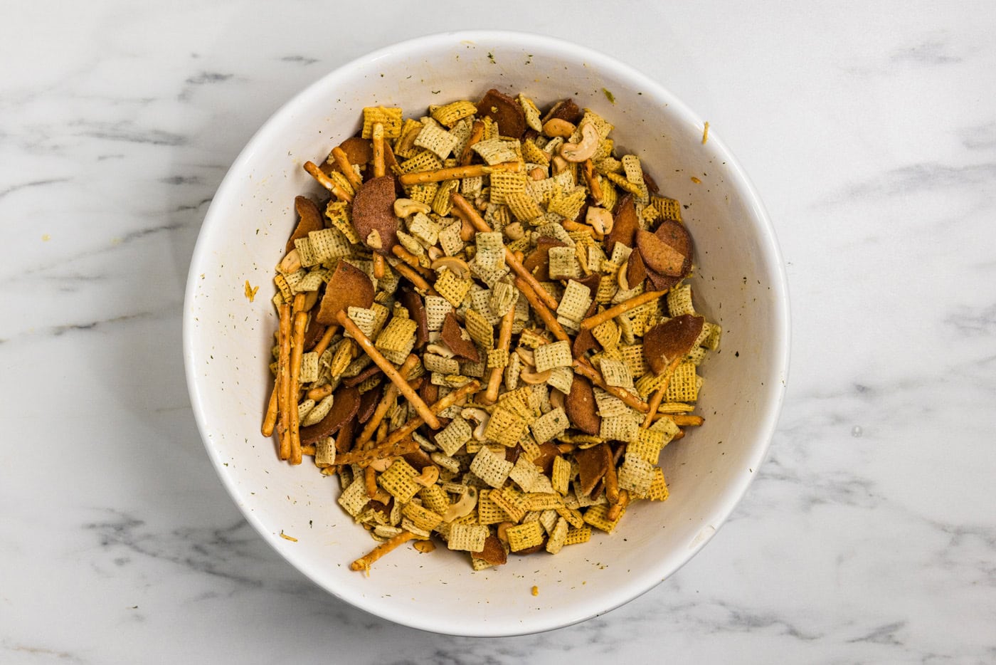 Dill pickle chex mix ingredients mixed in a bowl