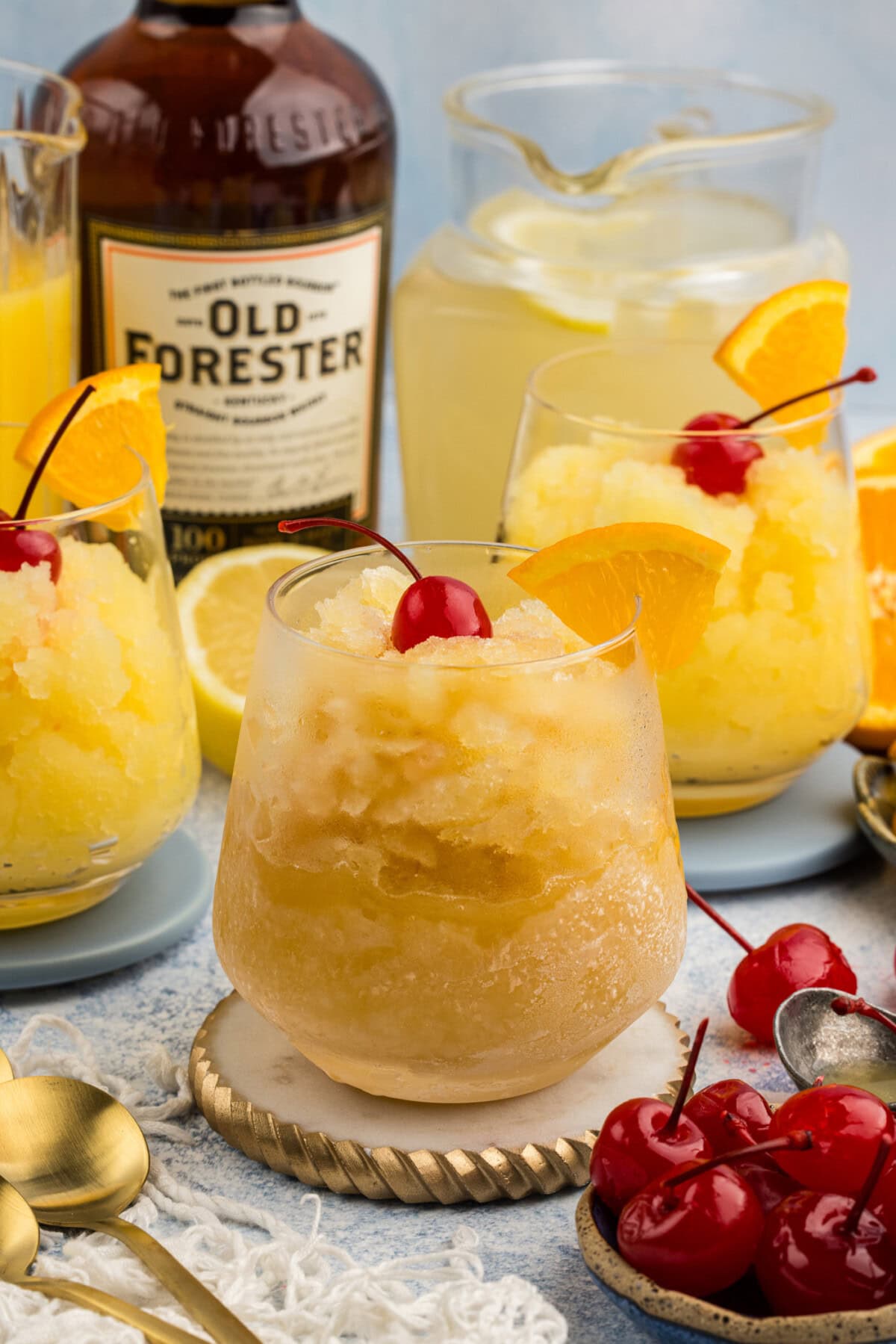 Easy Bourbon Slush in a glass with bottle in background