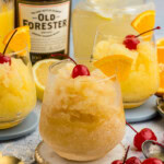 Easy Bourbon Slush in a glass with bottle in background