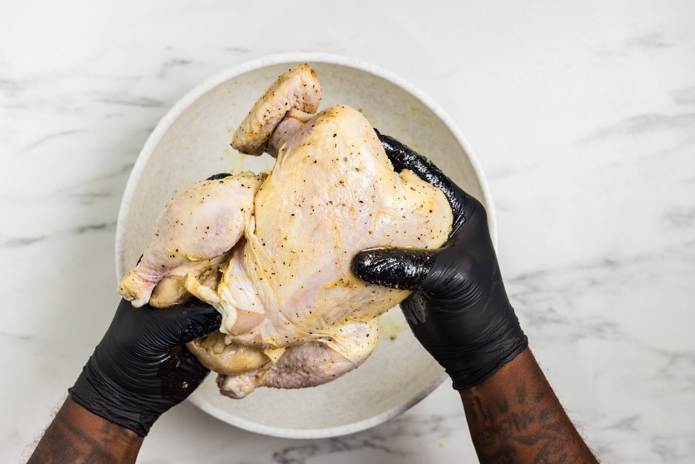 rubbing seasonings on chicken