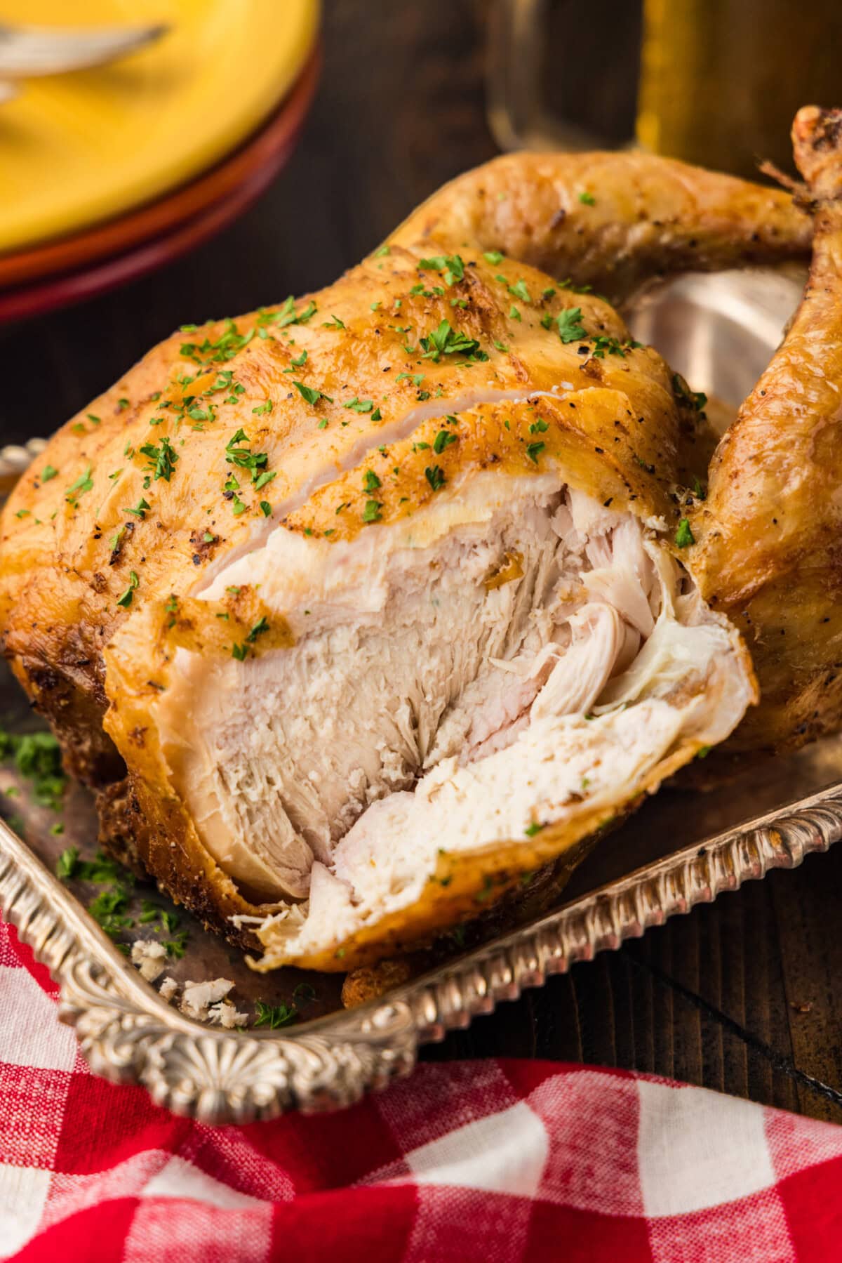 whole smoked chicken in tray that has been sliced into