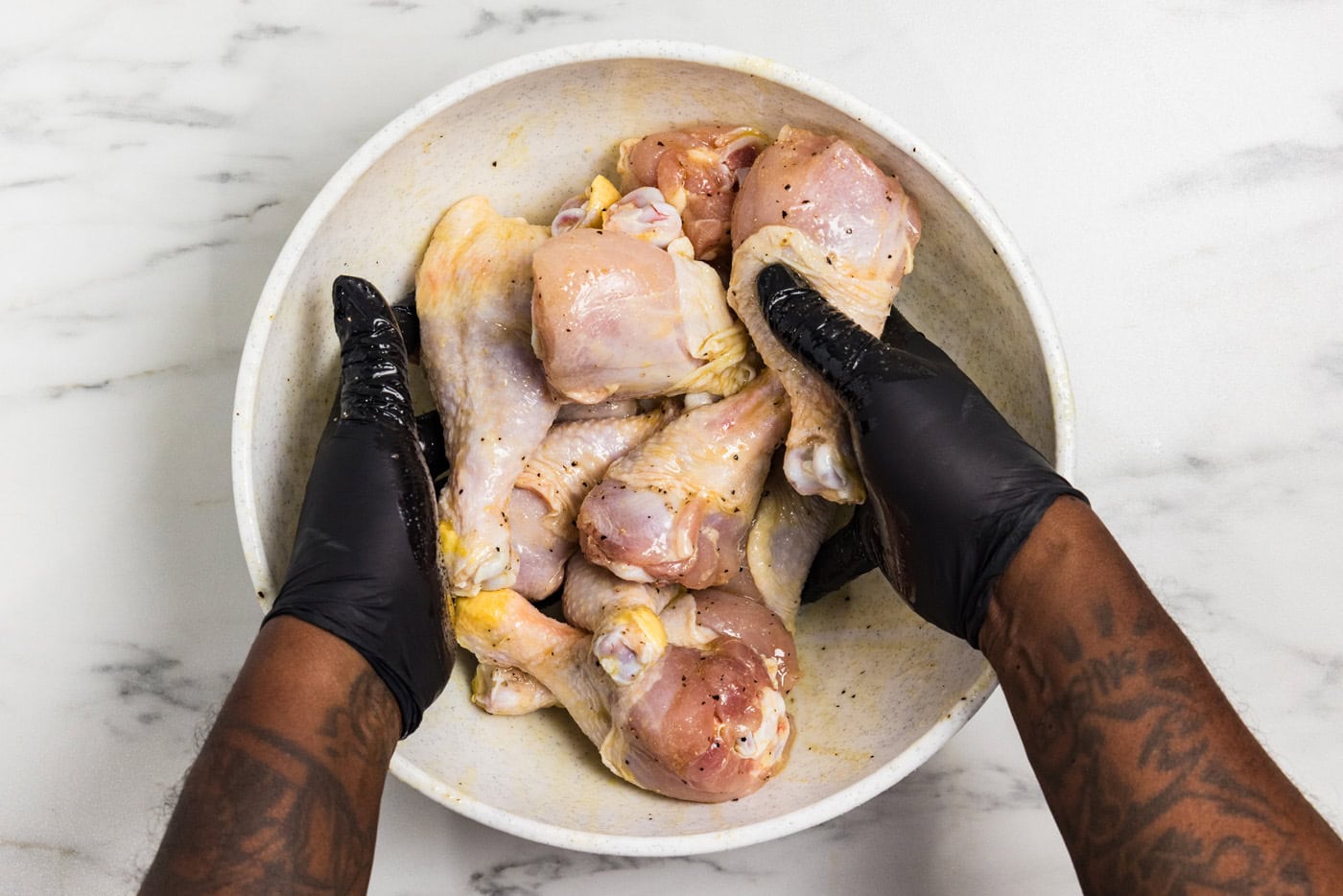 mixing seasoning onto chicken legs