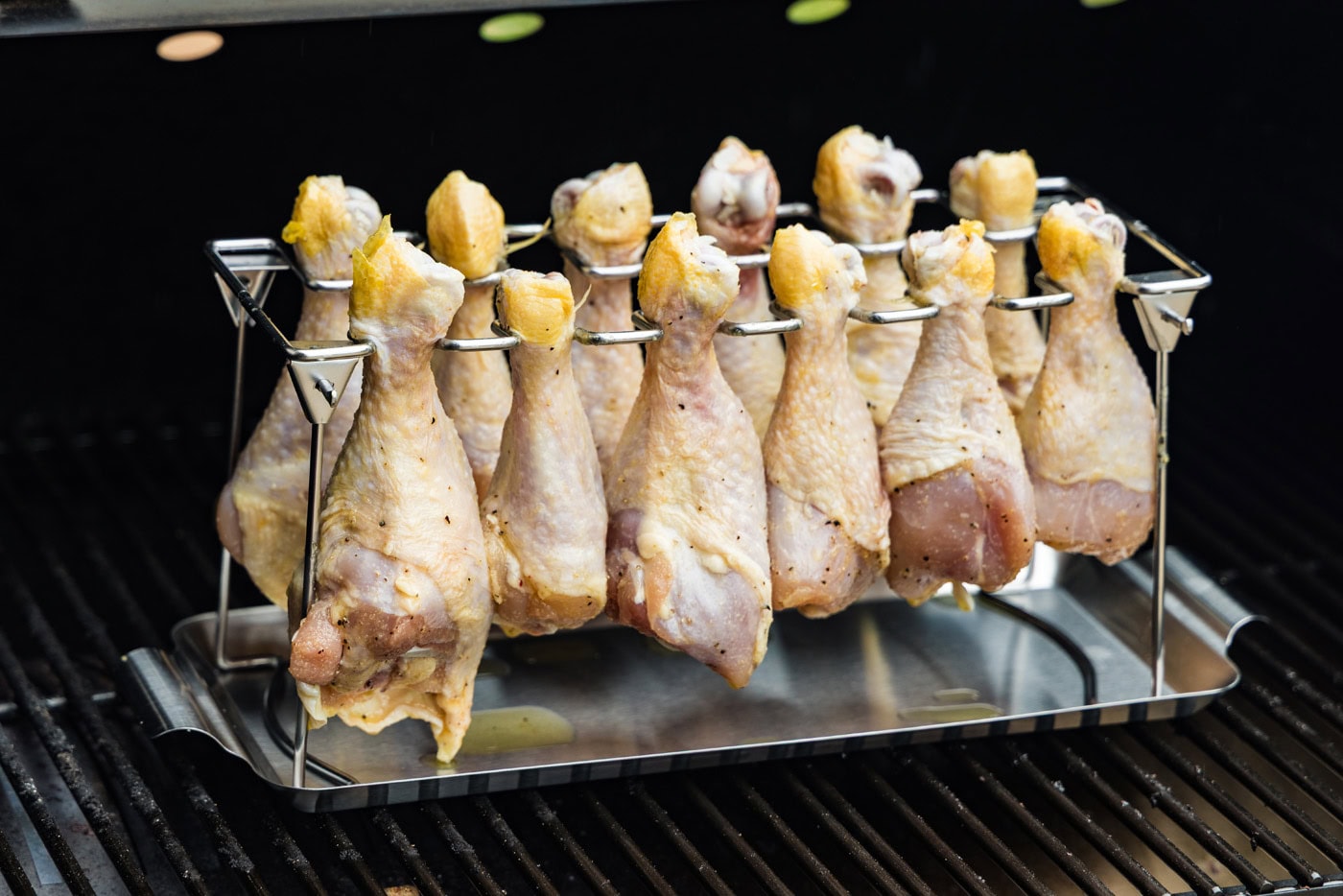 chicken drumsticks on a chicken leg rack on smoker
