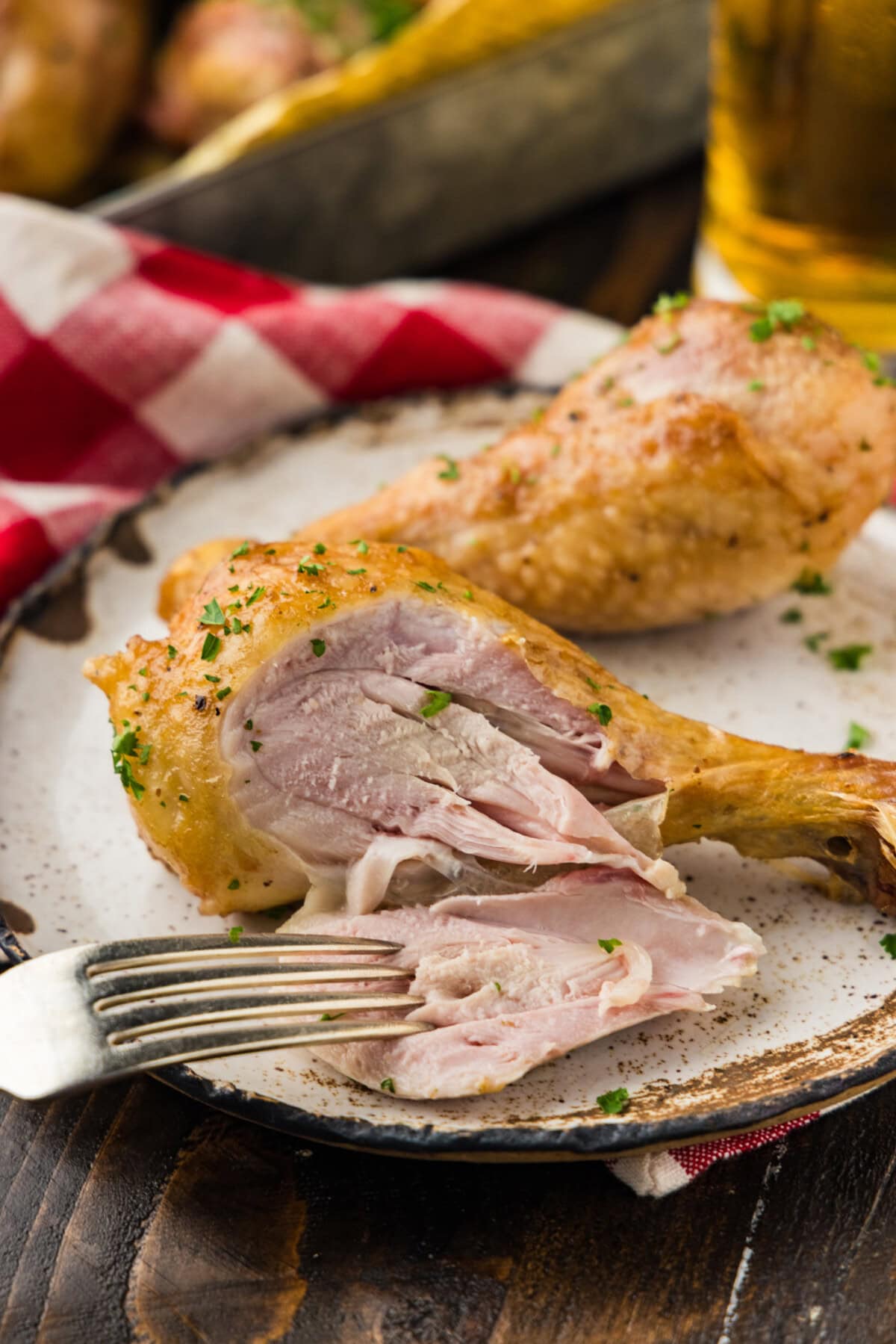 sliced open smoked chicken drumstick with fork