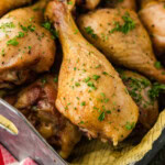 close up of smoked chicken drumsticks in tray